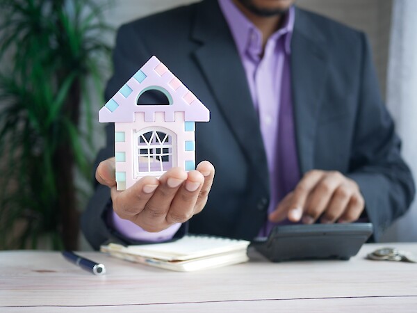 man holding house
